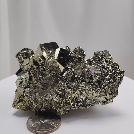 Shangbao Pyrite is a variety of pyrite, a sulfide mineral with the chemical formula FeS₂. Known for its metallic luster and brassy gold color, pyrite crystallizes in the isometric system, often forming cubic, octahedral, or pyritohedral crystals.