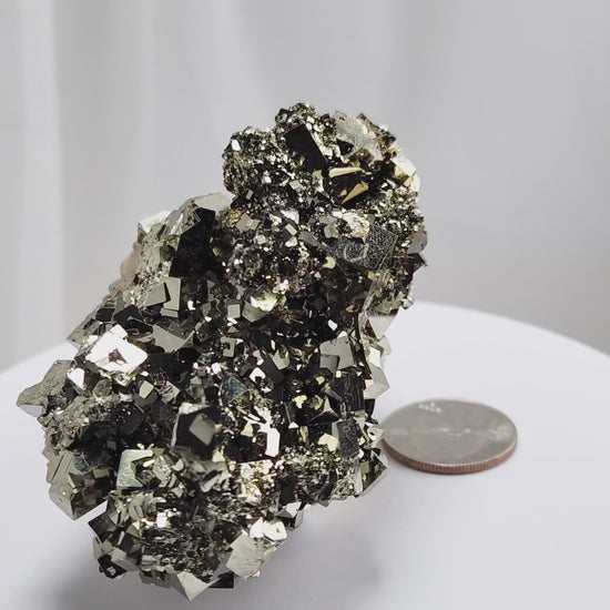 Shangbao Pyrite is a variety of pyrite, a sulfide mineral with the chemical formula FeS₂. Known for its metallic luster and brassy gold color, pyrite crystallizes in the isometric system, often forming cubic, octahedral, or pyritohedral crystals.