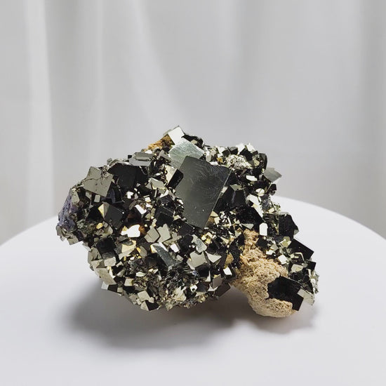 Shangbao Pyrite is a variety of pyrite, a sulfide mineral with the chemical formula FeS₂. Known for its metallic luster and brassy gold color, pyrite crystallizes in the isometric system, often forming cubic, octahedral, or pyritohedral crystals.