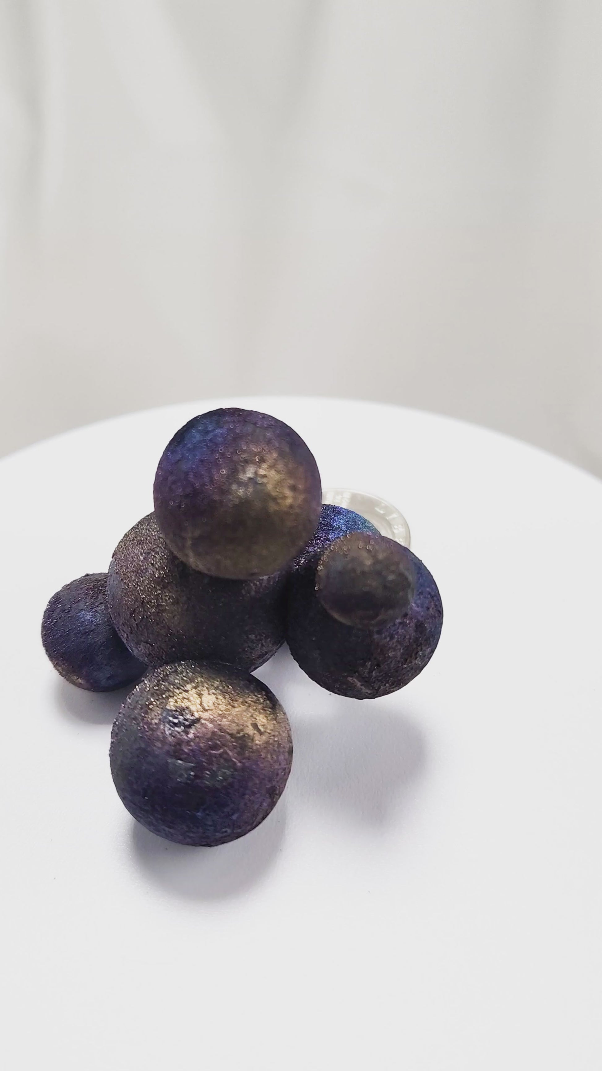 These stunning Chalcopyrite copper iron sulfide spheres (CuFeS₂) showcase a metallic golden luster with vibrant iridescent hues of purple, blue, and green. Formed through hydrothermal processes in Daye, Hubei Province, they crystallize in the tetragonal system and are valued for their aesthetic and energetic properties.